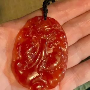 Carved red jade pendant. 20.9 grams in weight.